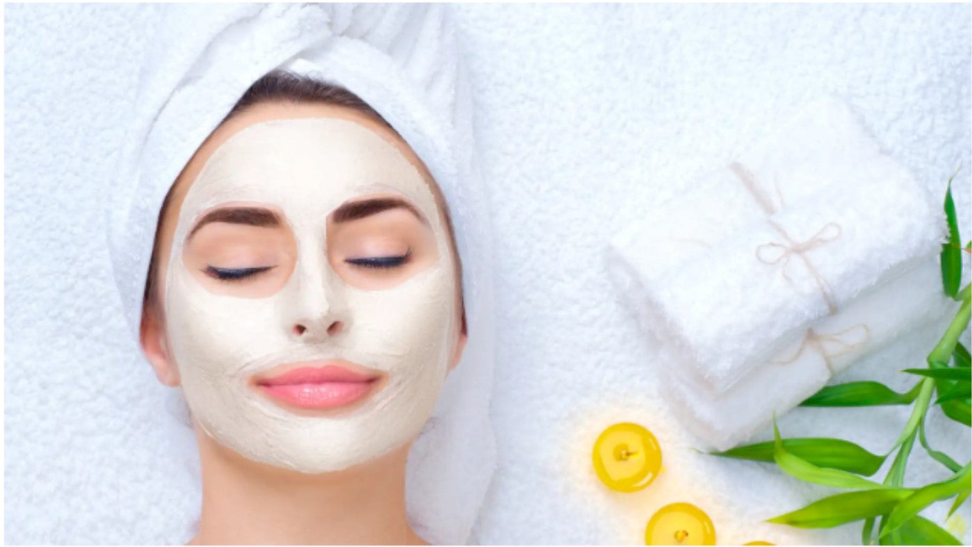 Woman doing a mindful skincare routine, wearing a facial